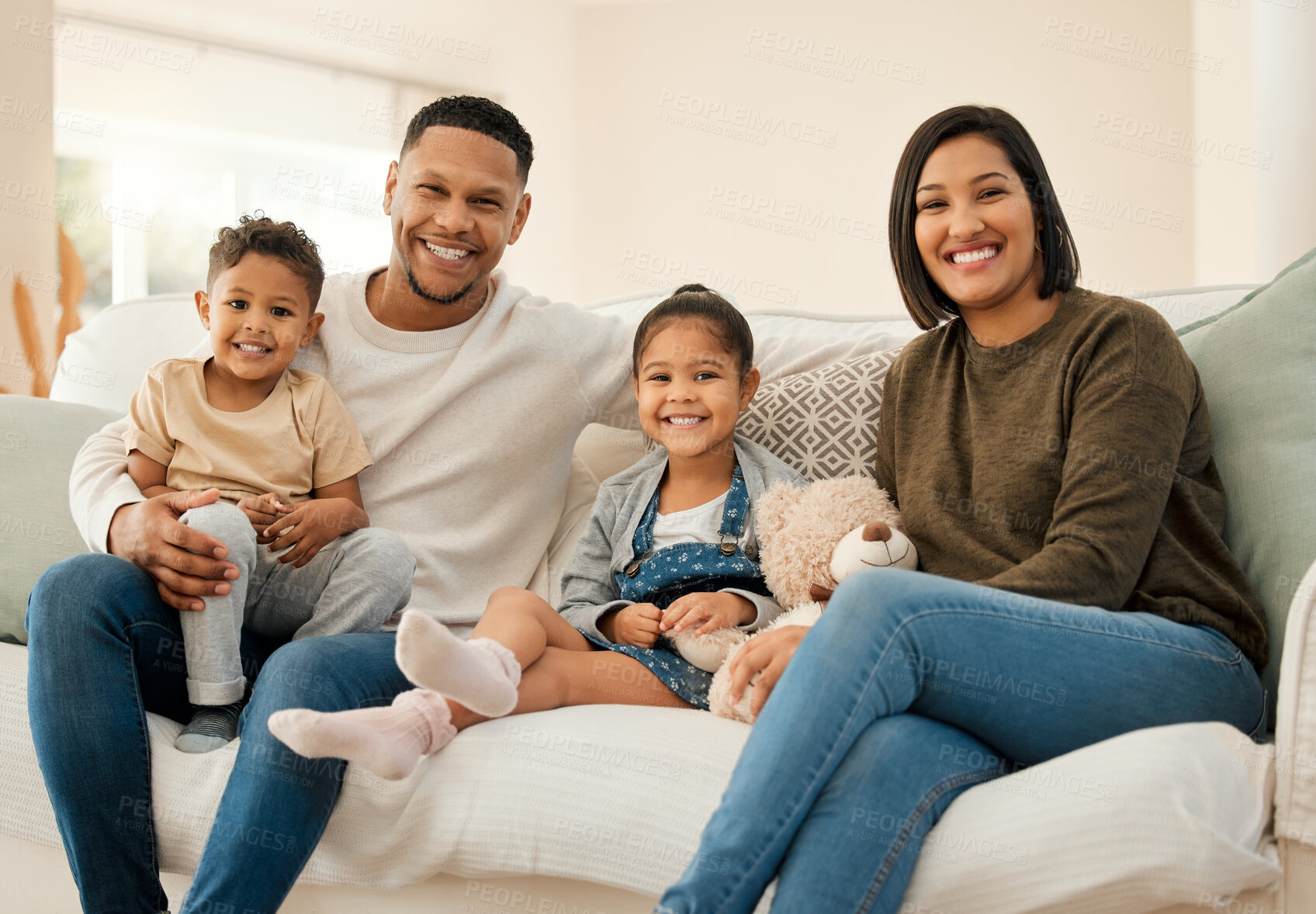 Buy stock photo Portrait, happy and family relax at house with kids for love, care and bonding support in living room together. Smile, parents and children with embrace for weekend peace, playful morning and memory