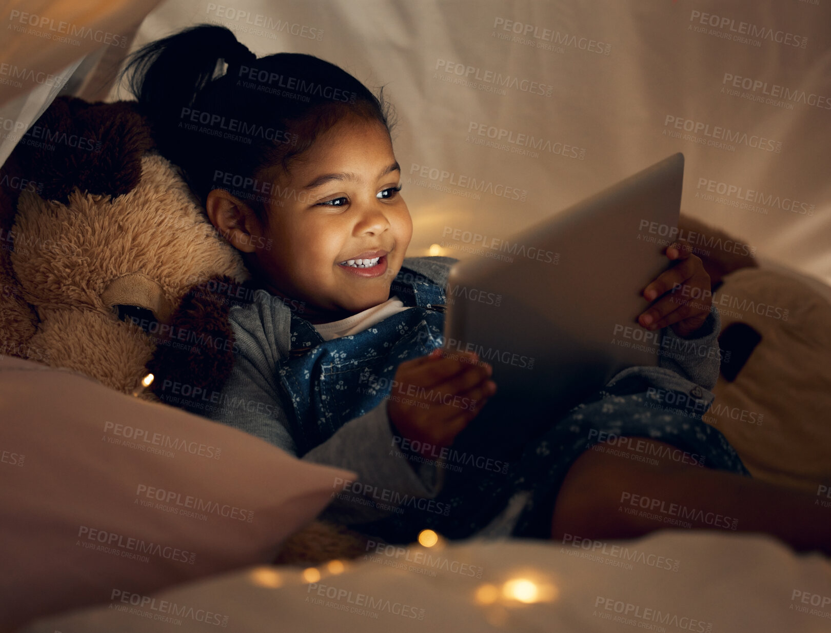 Buy stock photo Home, night and girl with tablet, bedroom and relax with internet, connection and smile. Apartment, bedtime and happy kid with technology, evening and childhood with digital app, dark and ebook