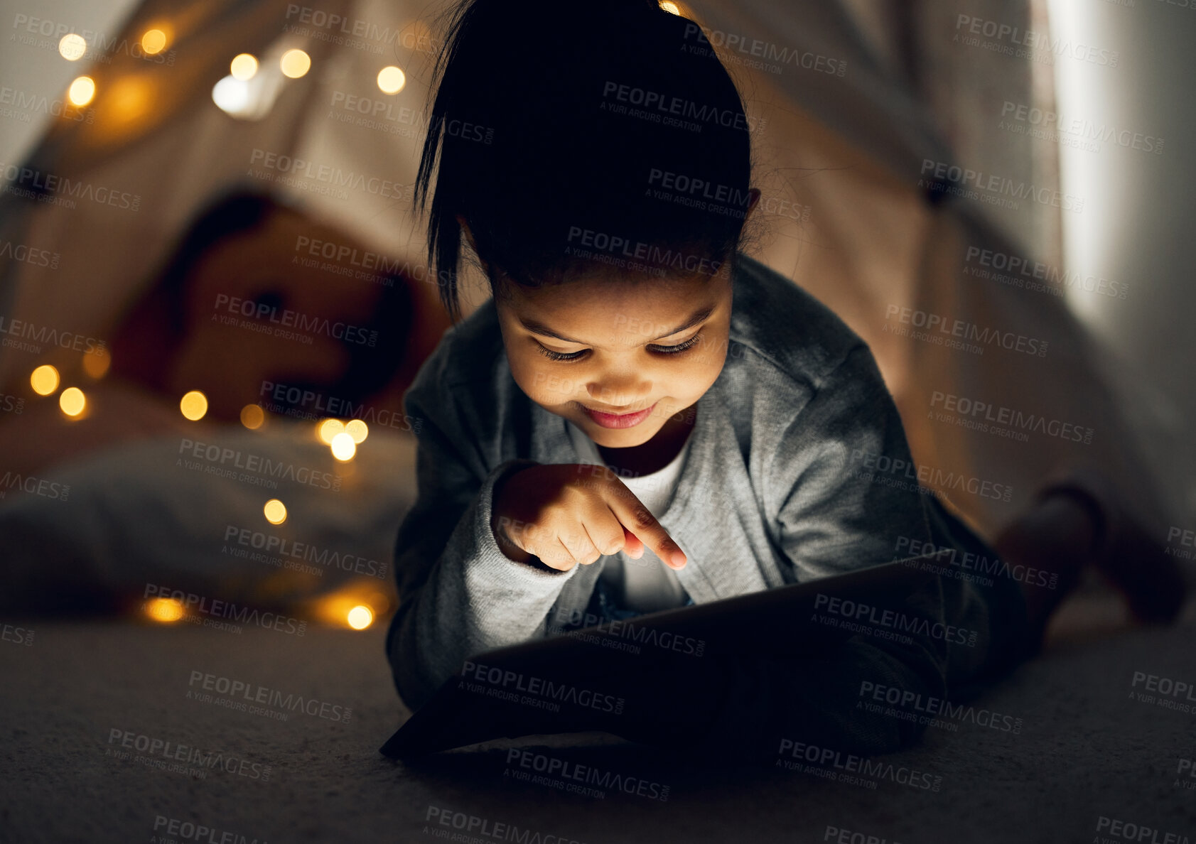 Buy stock photo House, dark and girl with tablet, bedroom and relax with internet, connection and ebook. Apartment, bedtime and happy kid with technology, evening and childhood with digital app, rest or website info