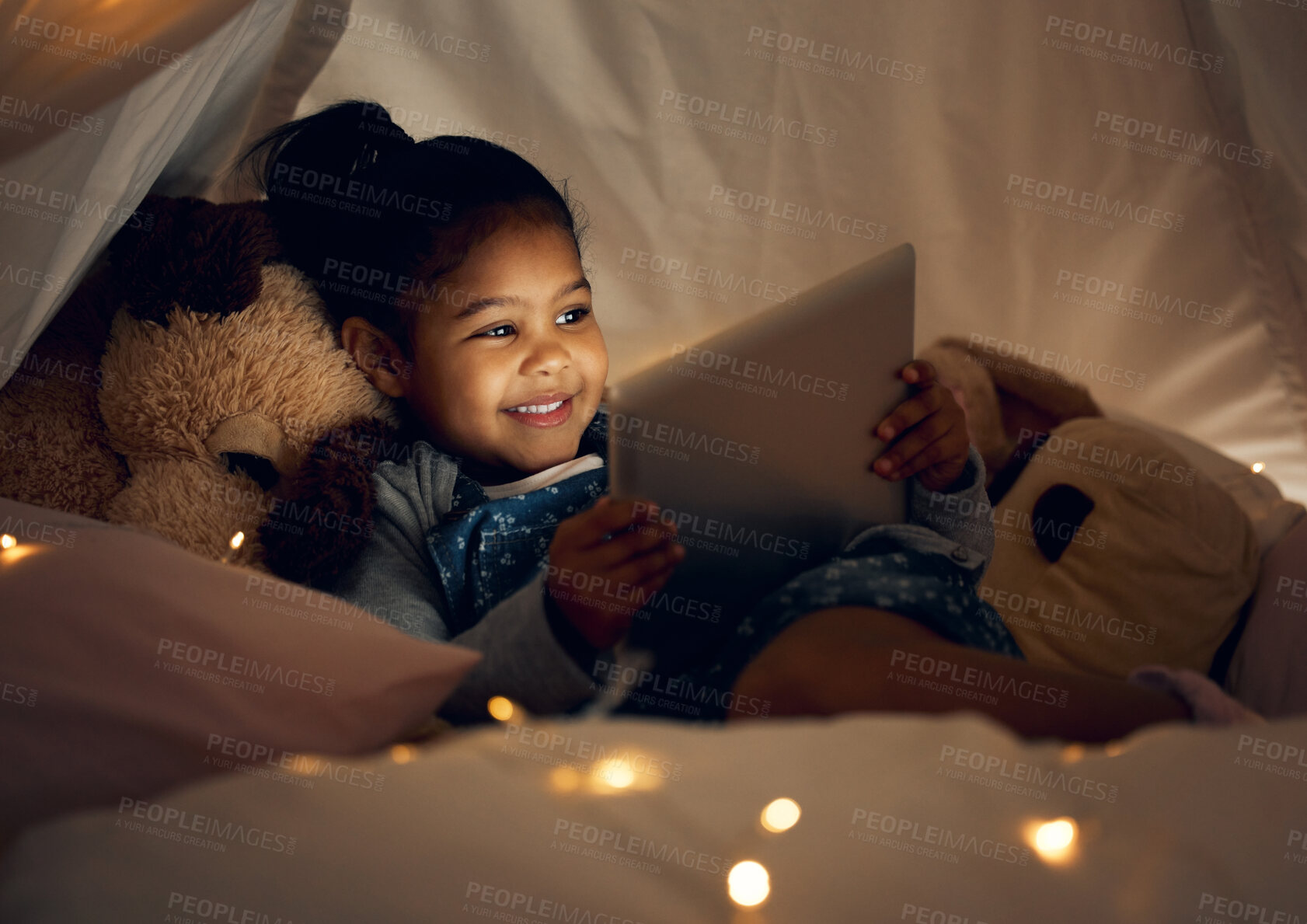 Buy stock photo House, night and girl with tablet, bedroom and relax with internet, connection and smile. Apartment, bedtime and happy kid with technology, evening and childhood with app for ebook, dark and story