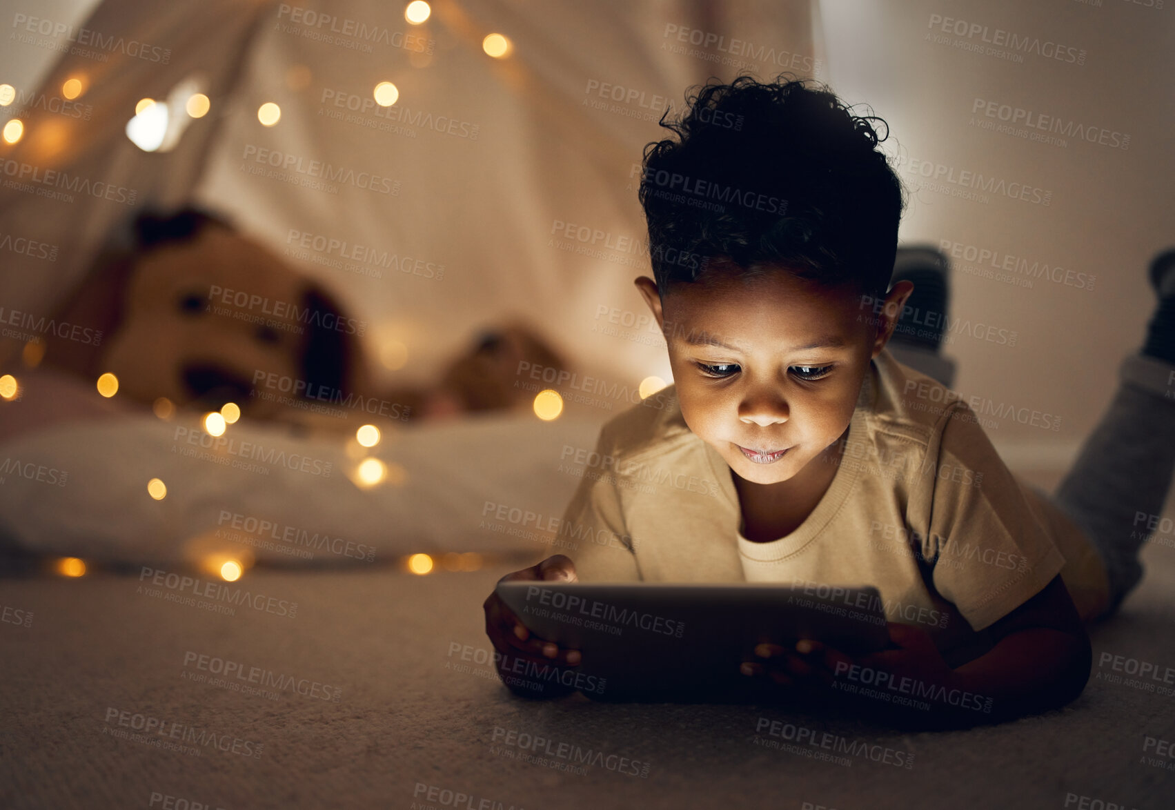 Buy stock photo Home, night and boy with tablet, bedroom and relax with internet, connection and story. Apartment, bedtime and happy kid with technology, evening and communication with digital app, dark and ebook