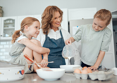 Buy stock photo Shot of a grandmother baking with her two granddaughters at home