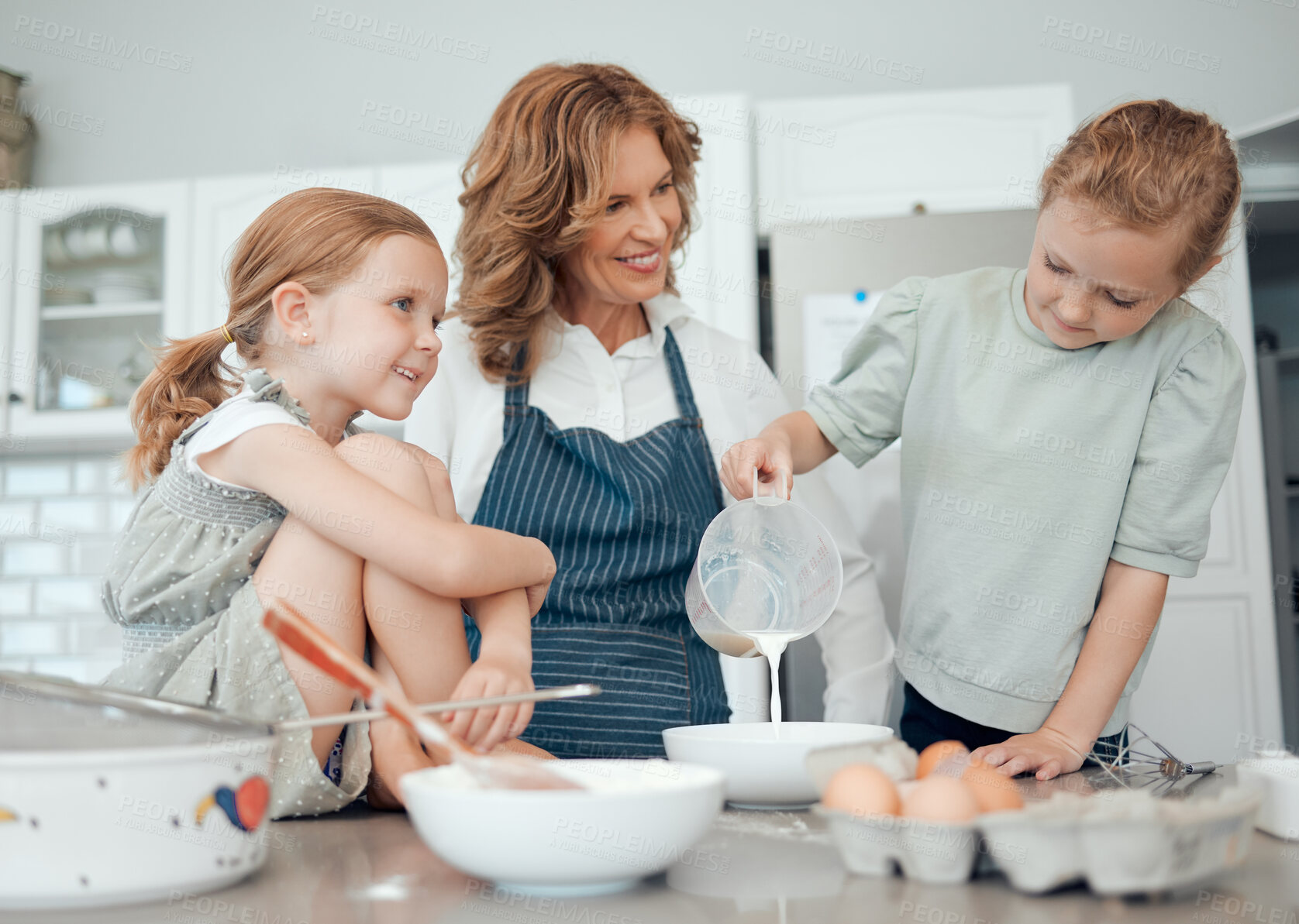 Buy stock photo Grandmother, help and children with home, kitchen and learning with measuring jug for house pastry or dessert cake. Happy, family and teaching cooking kids baking pudding, cookies or bakery recipe