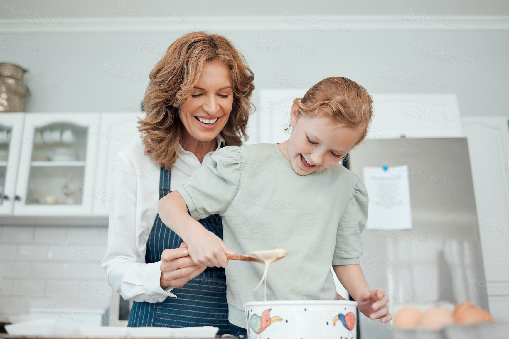 Buy stock photo Grandmother, teaching and girl baker for learning in kitchen, house or home for pastry or mixing cake dessert. Happy smile, bonding and cooking child help baking pudding, cookies or bakery recipe