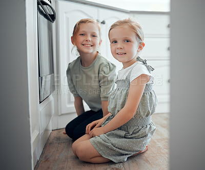 Buy stock photo Portrait of two little girls checking what is baking in an oven at home