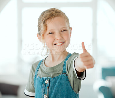 Buy stock photo Shot of an adorable little girl standing alone at home and showing a thumbs up