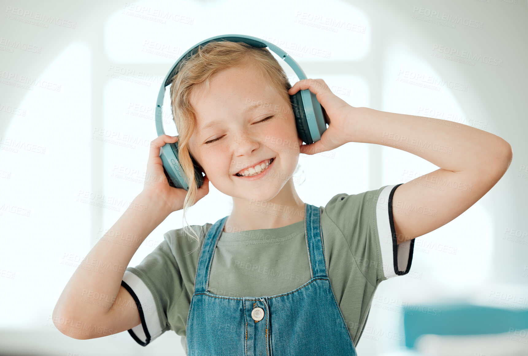 Buy stock photo Listening, music and child with headphones, enjoy and peace with streaming on app, online and audio. Home, podcast and girl with subscription for sound, lounge and fun with radio, relax and hear