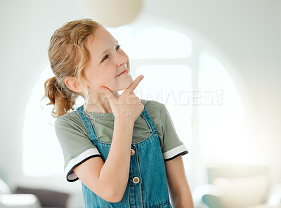 Buy stock photo Shot of an adorable little girl standing alone at home and looking contemplative