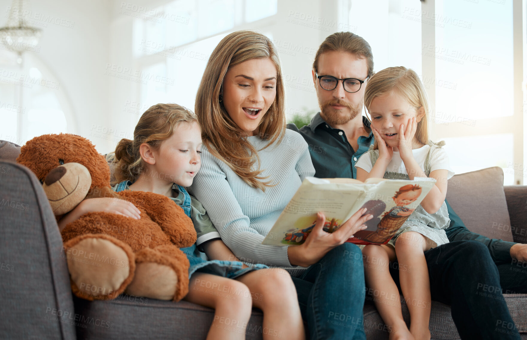 Buy stock photo Book, surprise and storytelling with family on sofa in living room of home together for education or learning. Fantasy, literature or wow with mother, father and girl children reading in apartment