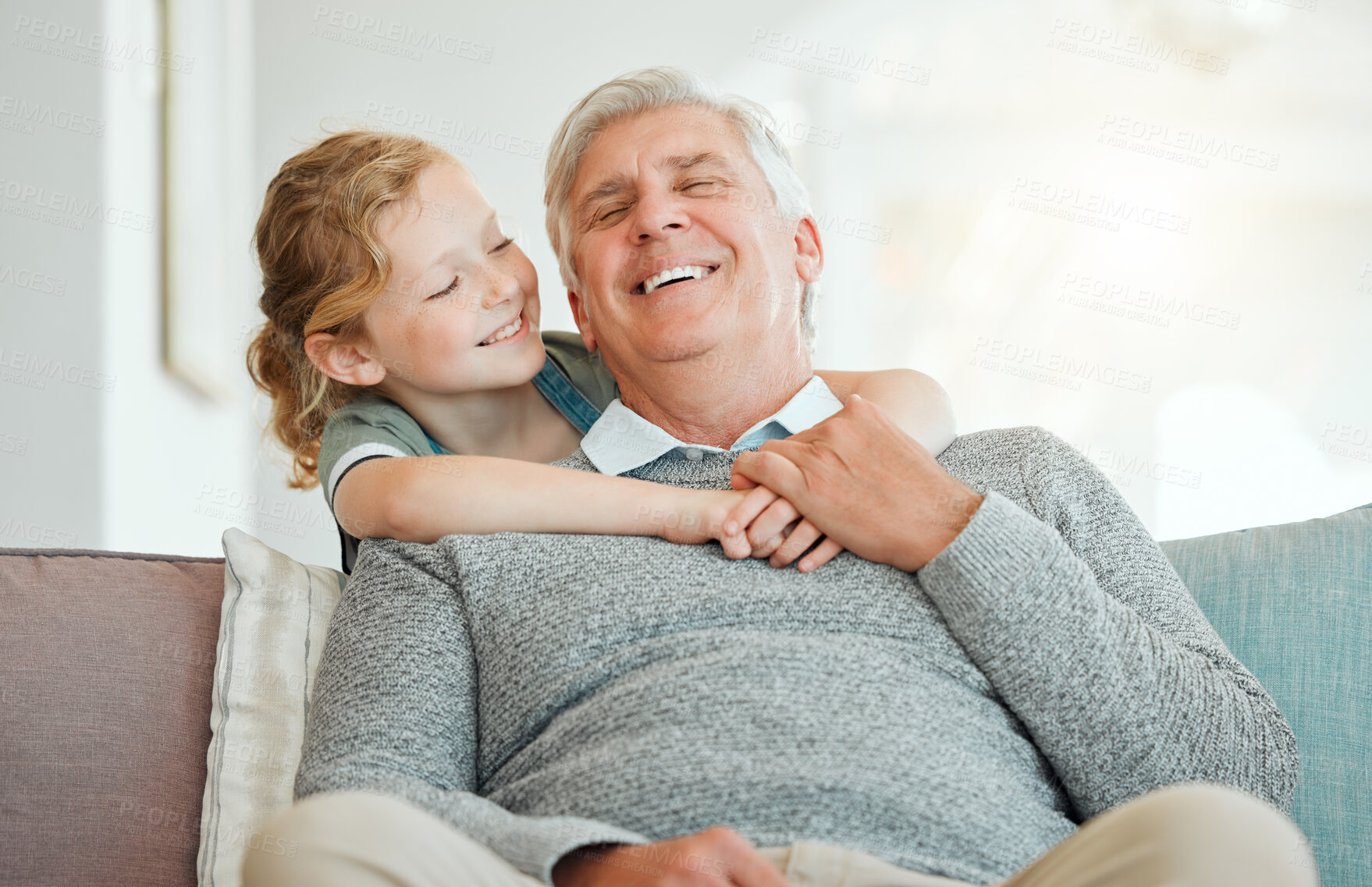 Buy stock photo Girl, grandfather and relax on sofa with smile for bonding, care and embrace on weekend with childhood love. Grandpa, kid and happy together in family house with hug, affection and laughing on couch.