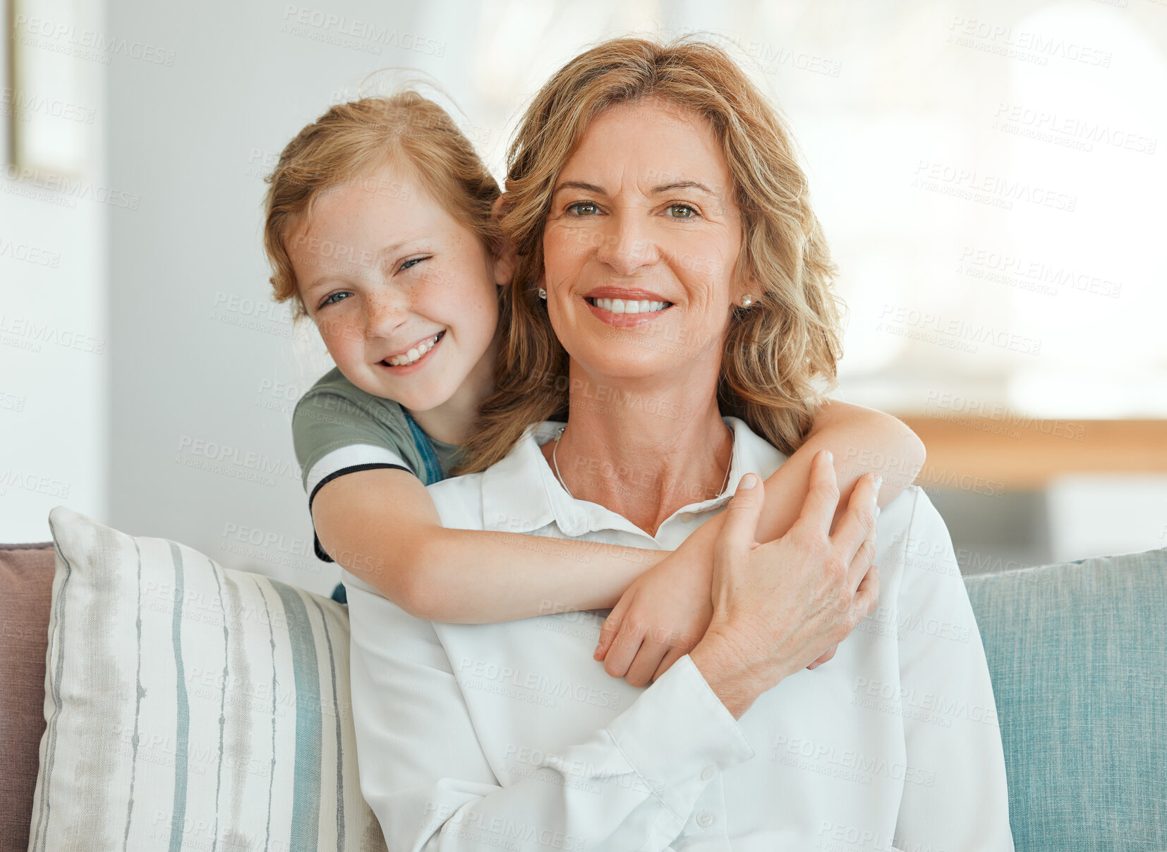 Buy stock photo Girl, grandmother and happy on sofa with portrait for bonding, care and embrace on weekend with childhood love. Grandma, kid and smile together in family house with hug, affection and relax on couch.