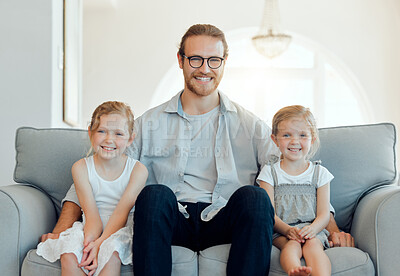 Buy stock photo Shot of a father bonding with his daughters on the sofa at home