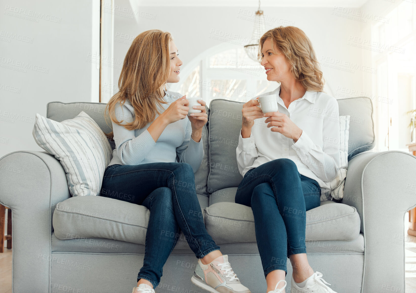 Buy stock photo Shot of a mother and daughter bonding on the couch together at home