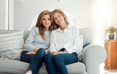 Buy stock photo Shot of a mother and daughter bonding on the couch together at home