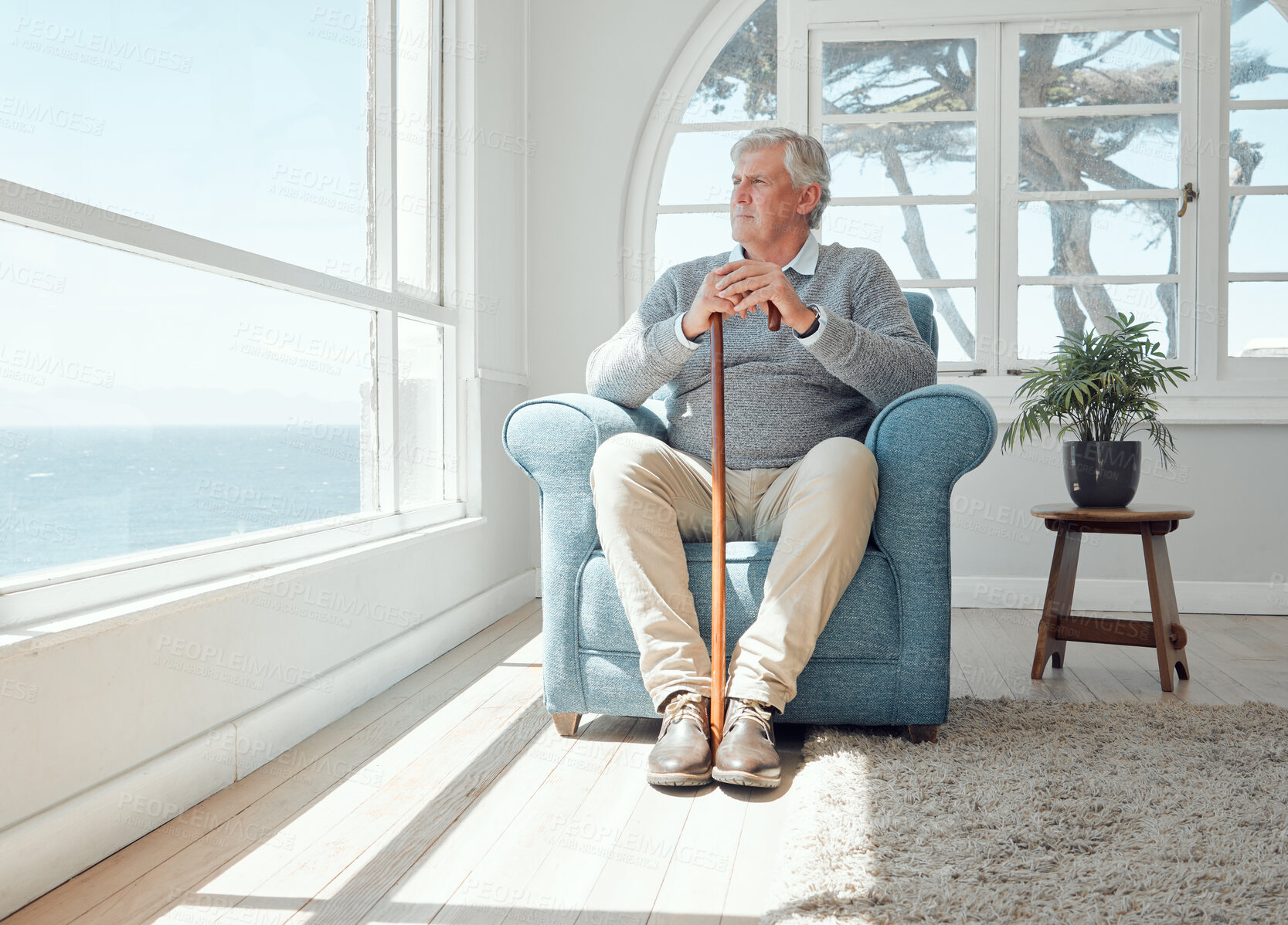 Buy stock photo Shot of an elderly man enjoying the view from his window