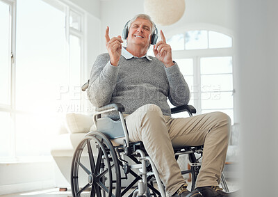 Buy stock photo Shot of an elderly man enjoying some music while sitting in the lounge at home