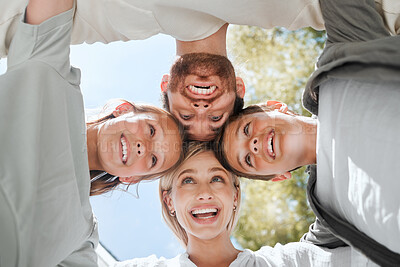 Buy stock photo Shot of a couple and their two children standing together in a huddle
