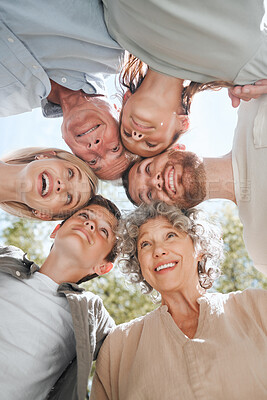 Buy stock photo Shot of a multi-generational family standing together in a huddle