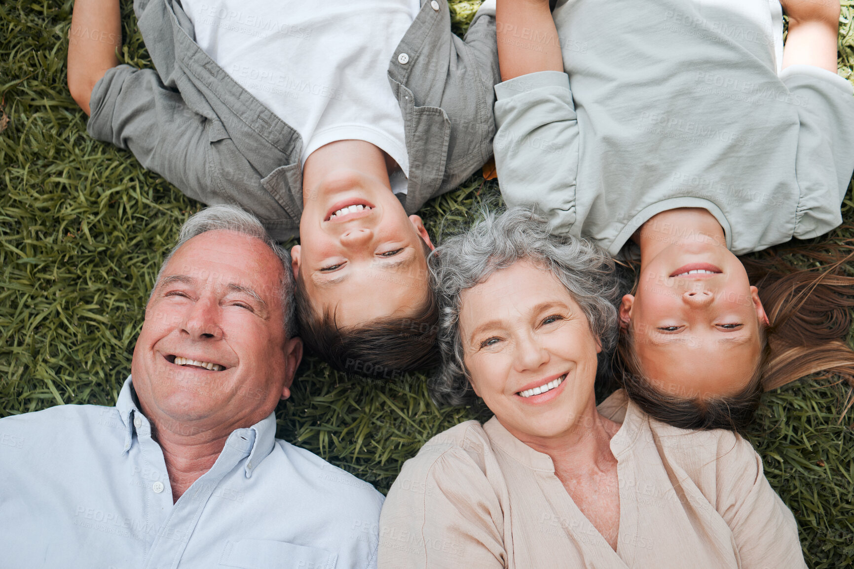 Buy stock photo Grass, portrait and smile of grandparents with children outdoor on lawn together for bonding or visit. Face, relax or wellness with happy senior people and sibling kids in backyard from above