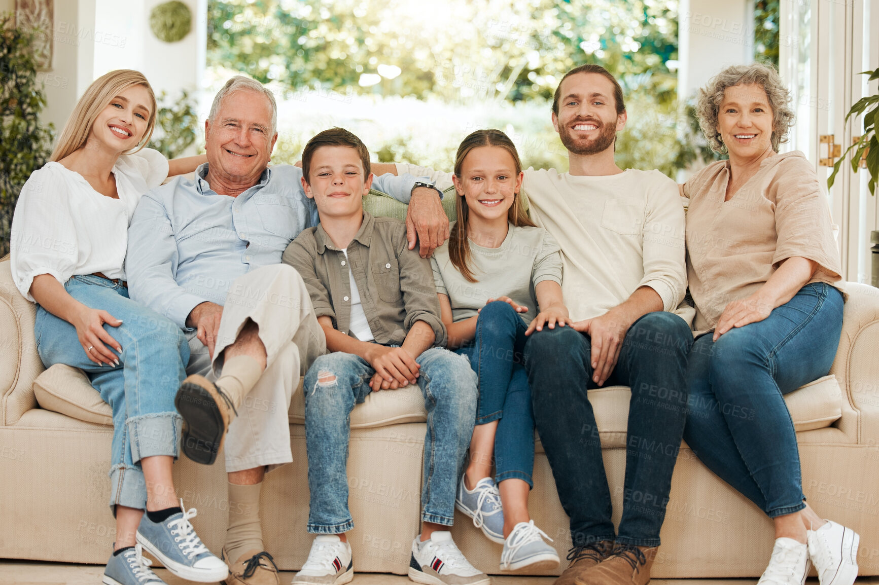 Buy stock photo Family, portrait and home with kids, grandparents and parents together with smile and hug. Living room, couch and happy from bonding, care and support with love and generations in lounge with joy