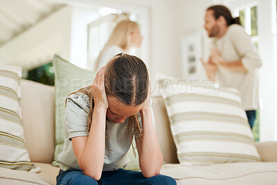 Buy stock photo Shot of a young girl covering her ears while her parents argue