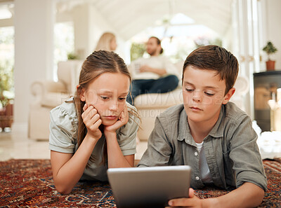 Buy stock photo Shot of a young brother and sister playing together while using a digital tablet