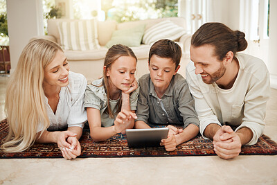 Buy stock photo Family, children and tablet with internet, app and parents watching cartoon on living room floor together. Movies, kids and subscription with mother, father and siblings bonding at home in lounge