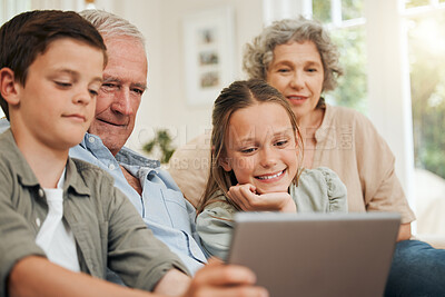 Buy stock photo Shot of grandparents spending time with their grandchildren while using a digital tablet to take selfies