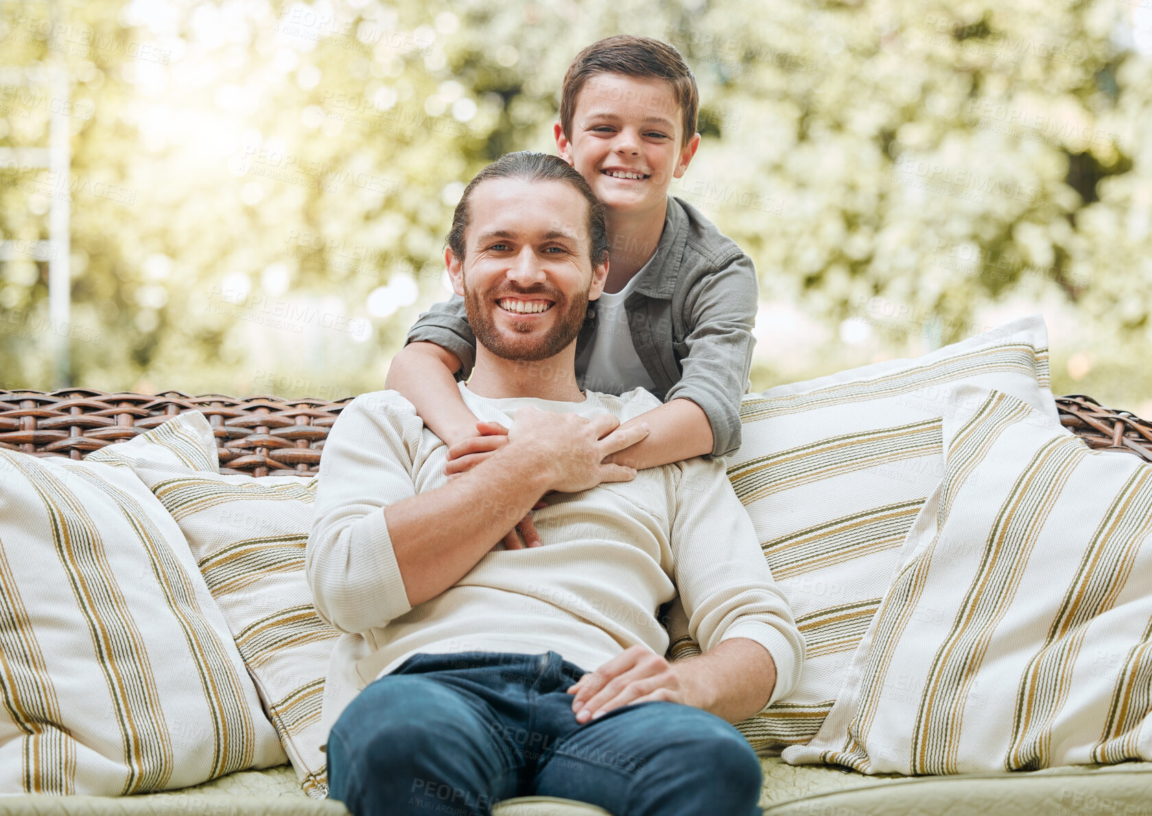 Buy stock photo Shot of a handsome young man sitting outside with his son