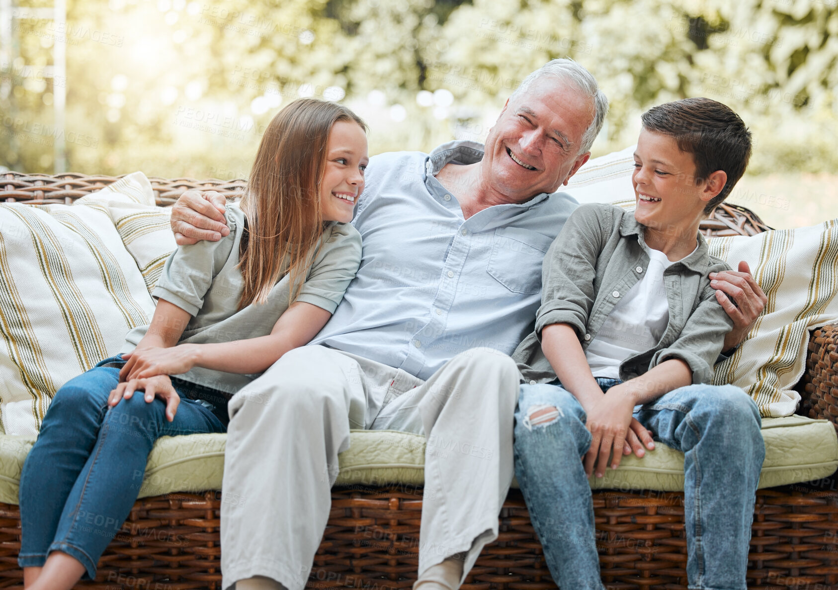 Buy stock photo Grandfather, kids and laugh in patio on sofa at home for bonding, support and care. People, family and happy or smile outside on visit as babysitter for break, relax and rest on couch for fun