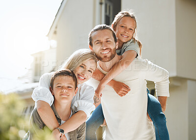 Buy stock photo Shot of a couple and their two children standing together outside