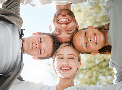 Buy stock photo Shot of a couple and their two children standing together in a huddle