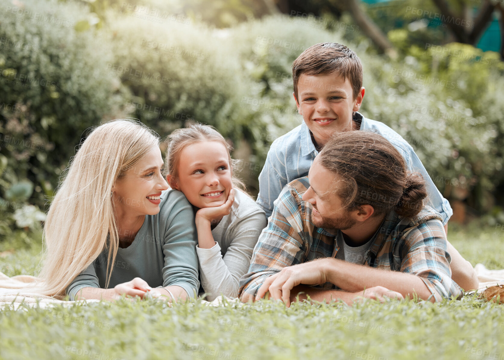 Buy stock photo Family, relax and garden hug for love, outdoor childcare and bonding together in Scotland. Parents, countryside and embrace children for security in relationship, vacation picnic and holiday trip