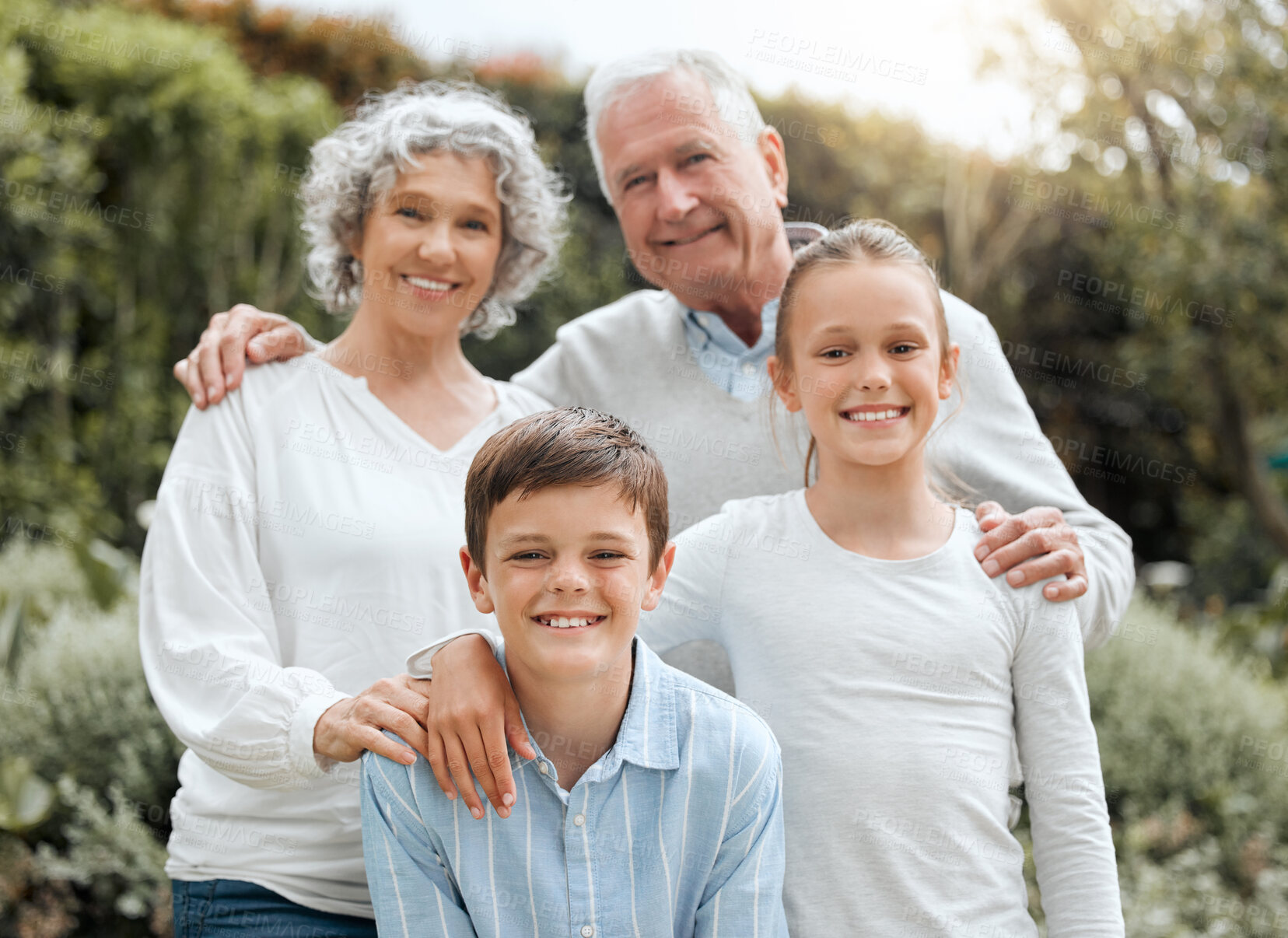 Buy stock photo Shot of two siblings posing for a picture with their grandparents outside