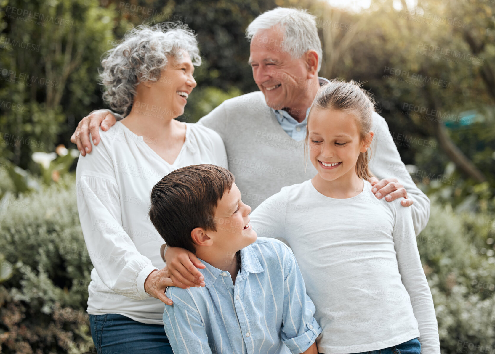 Buy stock photo Grandparents, laughing and garden hug with children, outdoor love and bonding together in Scotland. Old people, countryside and embrace kids for security in relationship, weekend visit and holiday