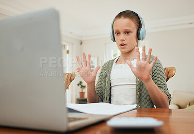 Buy stock photo Shot of a young girl attending her online class at home