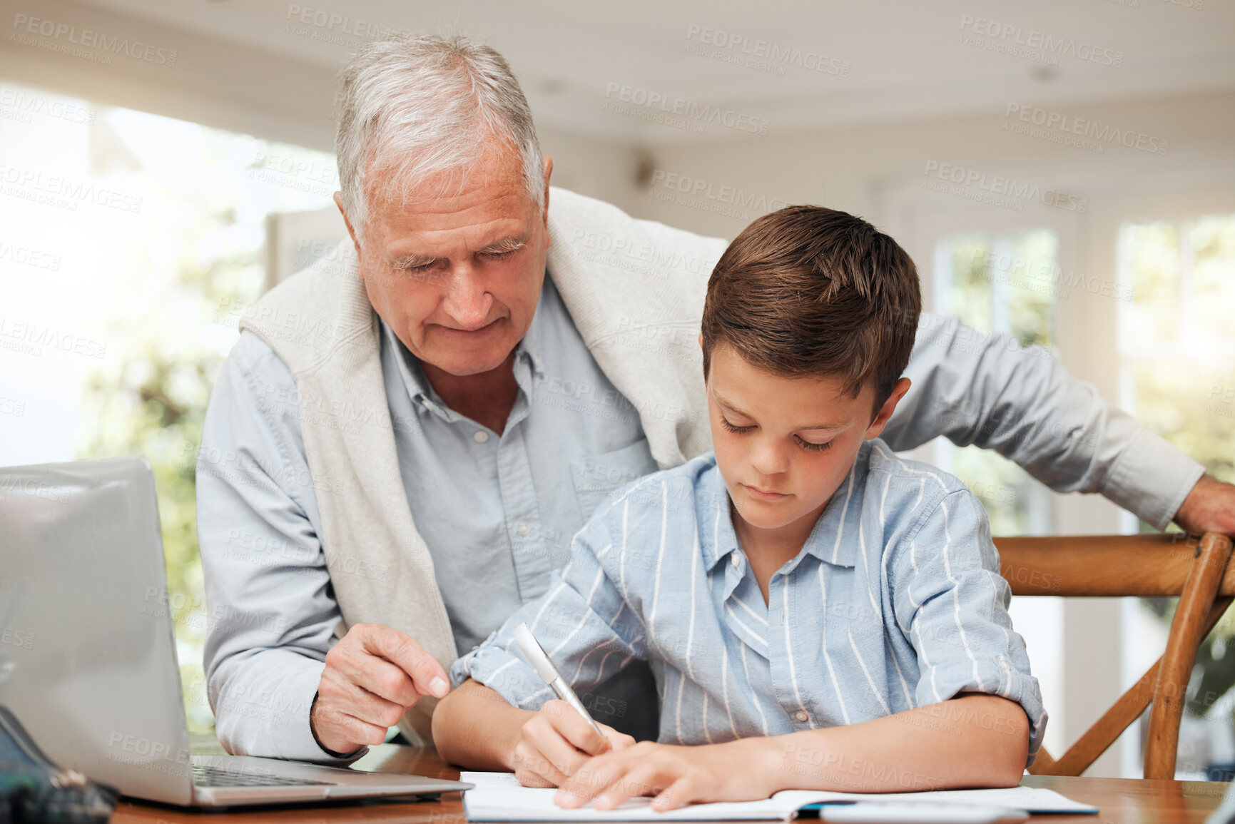 Buy stock photo Grandparent, boy and serious with homework in home for education, learning and support with care. People, family and laptop on history research for child development, growth and project with notebook