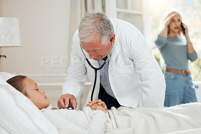 Buy stock photo Shot of a mature doctor listening to a little girl's heartbeat during a checkup at home