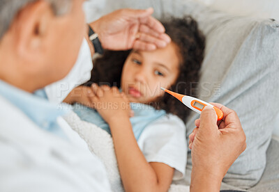 Buy stock photo Healthcare, doctor and checkup of child, thermometer and hand on forehead for temperature, cold and house. Sick, girl and help of medical professional in home, patient and infection of flu and kid