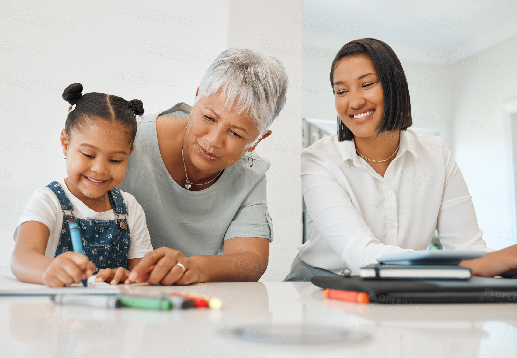 Buy stock photo Shot of a young girl getting help from her mother and grandma while doing her homework at home