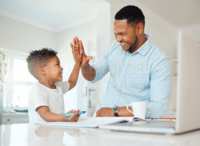 Buy stock photo Shot of a father and son doing homework together at home