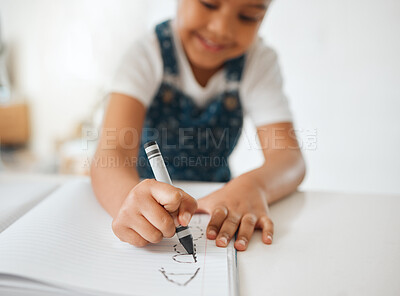 Buy stock photo Shot of a little girl doing her homework at home