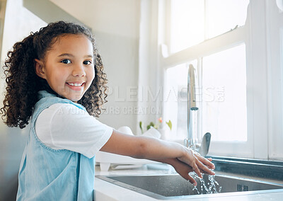 Buy stock photo Shot of a little girl washing her hands in the kitchen sink at home