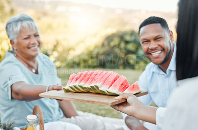 Buy stock photo Shot of a father and son enjoying watermelon at a picnic