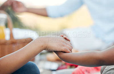 Buy stock photo Shot of a unrecognizable family having lunch together outside in the garden