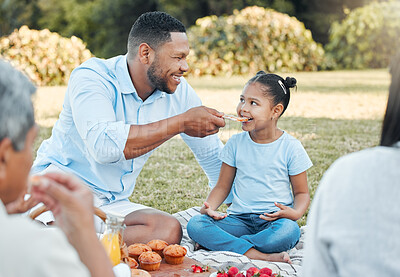 Buy stock photo Shot of a father and daughter enjoying pizza on a picnic