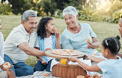 Buy stock photo Shot of a family enjoying a picnic in a park