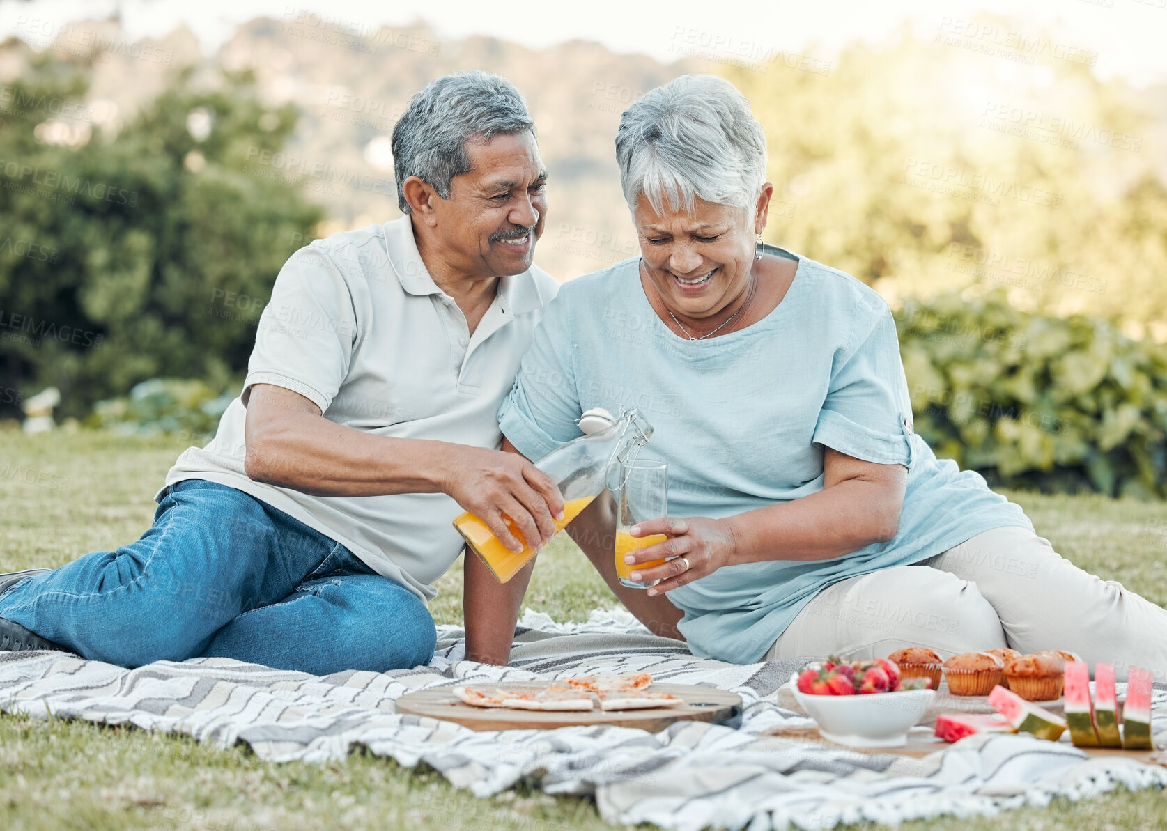Buy stock photo Shot of a senior couple enjoying a picnic outside