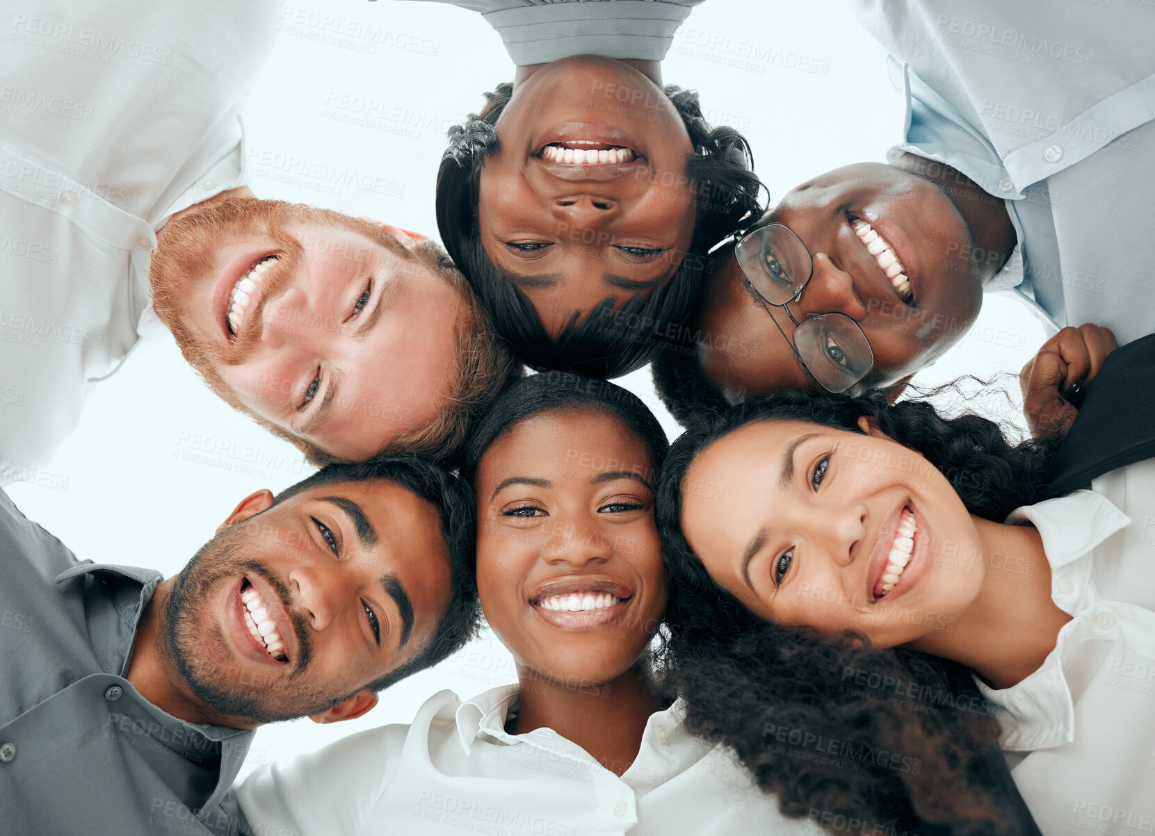 Buy stock photo Huddle, portrait and smile with business people in office from below for support or team building. Circle, diversity and face of happy employee group in workplace for corporate collaboration 