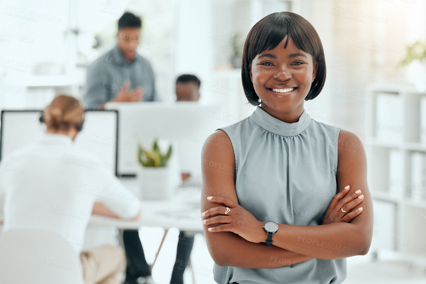 Buy stock photo Cropped portrait of an attractive young businesswoman standing with her arms folded in the office